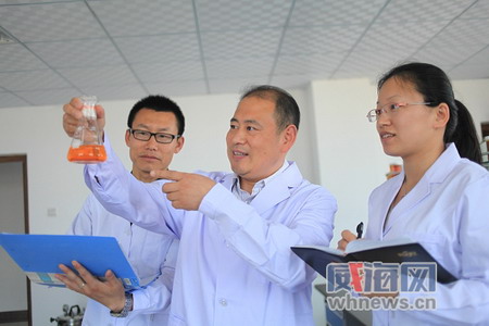 李洪社（中）在跟同事研究新产品